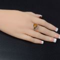 Woman wearing the Katharina Baltic Honey Amber Ring in Sterling Silver, showcasing genuine honey Baltic amber and polished 925 sterling silver in an elegant luxury jewelry lifestyle setting.