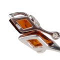 Close-up back view of Elena genuine Baltic honey amber earrings showing 925 sterling silver stamp, natural amber inclusions, and handcrafted silver setting on white background