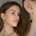 rose amber earrings on a model