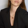 Woman wearing genuine Baltic honey amber oval pendant necklace in 925 sterling silver on 18 inch chain, elegant European amber jewelry shown on model with black blazer
