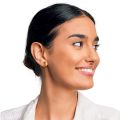 Model wearing genuine Baltic honey amber stud earrings in 18K gold plated 925 sterling silver, rectangular amber stones with bullet clutch backing, handcrafted Polish amber jewelry on female ear