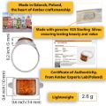 Infographic showing a sterling silver Baltic honey amber ring made in Gdańsk, Poland, with 925 silver hallmark, certificate of authenticity, rectangular amber stone dimensions (0.6 × 0.4 in), band profile, and lightweight 2.6 g design.