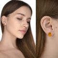 Model wearing genuine Baltic honey amber stud earrings in 925 sterling silver, oval amber cabochon stones with natural inclusions, minimalist amber jewelry shown on woman for everyday wear