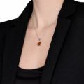 Model wearing genuine Baltic amber pendant necklace in 925 sterling silver, handcrafted in Poland, minimalist amber jewelry shown on neckline