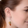 Model wearing genuine Baltic amber drop earrings in 925 sterling silver with multicolor amber stones, lightweight handcrafted earrings made in Poland