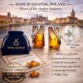 Infographic showing Baltic amber and 925 sterling silver stud earrings made in Gdańsk, Poland, displayed with a blue velvet Holiday Gift Shops pouch, certificate of authenticity, raw amber stones, Gdańsk waterfront skyline background, and product details including size, weight, and post back closure.