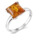 Baltic amber ring in sterling silver with a square honey-cognac amber stone, photographed at an angle on a clean background.