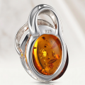 Close-up of genuine Baltic honey amber pendant set in 925 sterling silver, Beaming Sun handmade Polish amber jewelry showing natural inclusions and 925 stamp
