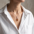 Sophia Baltic Amber Oval Pendant in Sterling Silver worn on a delicate silver chain, featuring a genuine oval Baltic amber gemstone in an elegant openwork sterling silver setting.