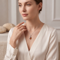 Yvonne Baltic Amber Pear-Shaped Pendant in Sterling Silver worn on a fine silver chain, featuring a genuine pear-shaped Baltic amber gemstone in an elegant sterling silver setting.