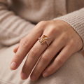 Nina Baltic Honey Amber Rectangular Adjustable Ring in Sterling Silver worn on a woman's finger, showcasing a vibrant honey amber stone and contemporary sterling silver design.