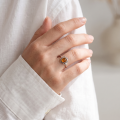 Woman wearing the Brittany Baltic Amber Ring in Sterling Silver, showcasing genuine Baltic amber and polished 925 sterling silver in an elegant luxury jewelry lifestyle setting.