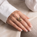 Woman wearing the Claudette Baltic Amber Ring in Sterling Silver, showcasing genuine Baltic amber and polished 925 sterling silver in an elegant luxury jewelry lifestyle setting.