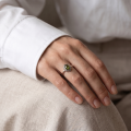 Woman wearing the Brittany Baltic Green Amber Ring in Sterling Silver, showcasing genuine green Baltic amber and polished 925 sterling silver in an elegant luxury jewelry lifestyle setting.