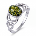 Baltic Green Amber Celtic Knot Ring in Sterling Silver featuring a genuine green Baltic amber gemstone set in polished 925 sterling silver with an intricate Celtic knot design, isolated on a white background.