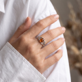 Woman wearing the Celtic Knots Baltic Honey Amber Ring in Sterling Silver, showcasing a genuine honey Baltic amber gemstone and elegant Celtic knot detailing in a luxury jewelry lifestyle setting.