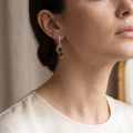 Woman wearing the Adrianna Baltic Honey Amber Earrings in Sterling Silver, showcasing genuine honey Baltic amber and polished 925 sterling silver in an elegant luxury jewelry lifestyle setting.