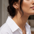 Woman wearing the Baltic Honey Amber Rectangle Stud Earrings in Sterling Silver, showcasing genuine honey Baltic amber and polished 925 sterling silver in an elegant luxury jewelry lifestyle setting.