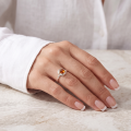 Woman wearing the Kaitlyn Baltic Honey Amber Ring in Sterling Silver, showcasing a genuine honey Baltic amber gemstone and polished 925 sterling silver in an elegant luxury jewelry lifestyle setting.