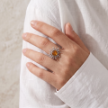 Woman wearing the GIA Certified Baltic Honey Amber Sun Ring in Sterling Silver, showcasing a genuine honey Baltic amber gemstone and polished 925 sterling silver in an elegant luxury jewelry lifestyle setting.
