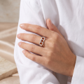 Woman wearing the Brayden Baltic Honey Amber Ring in Sterling Silver, showcasing a genuine honey Baltic amber gemstone and polished 925 sterling silver in an elegant luxury jewelry lifestyle setting.