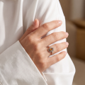 Woman wearing the Joan Baltic Honey Amber Ring in Sterling Silver, showcasing a genuine honey Baltic amber gemstone and polished 925 sterling silver in an elegant luxury jewelry lifestyle setting.