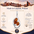 Ava Baltic Amber Pendant in Sterling Silver infographic highlighting authentic Baltic amber, 925 sterling silver, handcrafted craftsmanship, pendant dimensions, and Made in Gdańsk, Poland heritage.