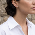 Woman wearing the Lina Baltic Honey Amber Earrings in Sterling Silver, showcasing genuine honey Baltic amber and polished 925 sterling silver in an elegant luxury jewelry lifestyle setting.