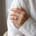 Woman wearing the Maja Baltic Honey Amber Adjustable Ring in Sterling Silver, showcasing a genuine honey Baltic amber gemstone and polished 925 sterling silver in an elegant luxury jewelry lifestyle setting.