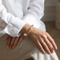 Woman wearing the Baltic Honey Amber Bracelet in Sterling Silver, showcasing genuine honey Baltic amber and polished 925 sterling silver in an elegant luxury jewelry lifestyle setting.