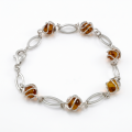 Baltic Honey Amber Bracelet in Sterling Silver featuring genuine honey Baltic amber gemstones set in polished 925 sterling silver, isolated on a white background.