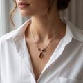 Woman wearing the Milena Baltic Honey Amber Necklace in Sterling Silver on a delicate silver chain, showcasing genuine honey Baltic amber and polished 925 sterling silver in an elegant luxury jewelry lifestyle setting.