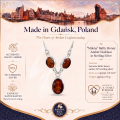 Milena Baltic Honey Amber Necklace in Sterling Silver infographic highlighting authentic honey Baltic amber, 925 sterling silver, handcrafted craftsmanship, necklace dimensions, and Made in Gdańsk, Poland heritage.