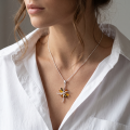 Woman wearing the Evelyn Baltic Amber Pendant in Sterling Silver on a delicate silver chain, showcasing genuine Baltic amber and polished 925 sterling silver in an elegant luxury jewelry lifestyle setting.