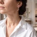 Woman wearing the Baltic Honey Amber Marquise Drop Stud Earrings in Sterling Silver, showcasing genuine honey Baltic amber and polished 925 sterling silver in an elegant luxury jewelry lifestyle setting.