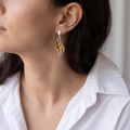 Woman wearing the Jennifer Baltic Honey Amber Earrings in Sterling Silver, showcasing genuine honey Baltic amber and polished 925 sterling silver in an elegant luxury jewelry lifestyle setting.