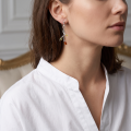 Woman wearing the Daisy Multicolor Baltic Amber Earrings in Sterling Silver, showcasing genuine multicolor Baltic amber and polished 925 sterling silver in an elegant luxury jewelry lifestyle setting.