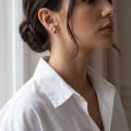 Woman wearing the Teddy Bear Baltic Honey Amber Earrings in Sterling Silver, showcasing genuine honey Baltic amber and polished 925 sterling silver in an elegant luxury jewelry lifestyle setting.