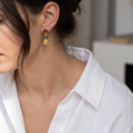Woman wearing the Anna Multicolor Baltic Amber Earrings in Sterling Silver, showcasing genuine multicolor Baltic amber and polished 925 sterling silver in an elegant luxury jewelry lifestyle setting.