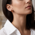 Woman wearing the Savannah Baltic Honey Amber Earrings in Sterling Silver, showcasing genuine honey Baltic amber and polished 925 sterling silver in an elegant luxury jewelry lifestyle setting.