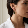 Woman wearing the Camila Baltic Green Amber Drop Earrings in Sterling Silver, showcasing genuine green Baltic amber and polished 925 sterling silver in an elegant luxury jewelry lifestyle setting.