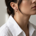 Woman wearing the Sienna Baltic Honey Amber Earrings in Sterling Silver, showcasing genuine honey Baltic amber and polished 925 sterling silver in an elegant luxury jewelry lifestyle setting.