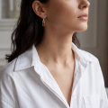 Woman wearing the Aretha Baltic Honey Amber Earrings in Sterling Silver, showcasing genuine honey Baltic amber and polished 925 sterling silver in an elegant luxury jewelry lifestyle setting.