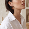 Woman wearing the Summer Baltic Honey Amber Earrings in Sterling Silver, showcasing genuine honey Baltic amber and polished 925 sterling silver in an elegant luxury jewelry lifestyle setting.