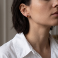 Woman wearing the Ellie Baltic Honey Amber Earrings in Sterling Silver, showcasing genuine honey Baltic amber and polished 925 sterling silver in an elegant luxury jewelry lifestyle setting.