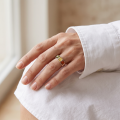 Woman wearing the Mila Multicolor Baltic Amber Ring in Sterling Silver, showcasing genuine multicolor Baltic amber and polished 925 sterling silver in an elegant luxury jewelry lifestyle setting.