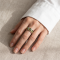 Woman wearing the Mila Baltic Green Amber Ring in Sterling Silver, showcasing genuine green Baltic amber and polished 925 sterling silver in an elegant luxury jewelry lifestyle setting.