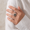 Woman wearing the Baltic Green Amber Sun Ring in Sterling Silver, showcasing genuine green Baltic amber and polished 925 sterling silver in an elegant luxury jewelry lifestyle setting.