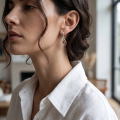 Woman wearing the Lydia Baltic Honey Amber Earrings in Sterling Silver, showcasing genuine honey Baltic amber and polished 925 sterling silver in an elegant luxury jewelry lifestyle setting.