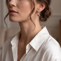 Woman wearing the Brianna Baltic Honey Amber Earrings in Sterling Silver, showcasing genuine honey Baltic amber and polished 925 sterling silver in an elegant luxury jewelry lifestyle setting.